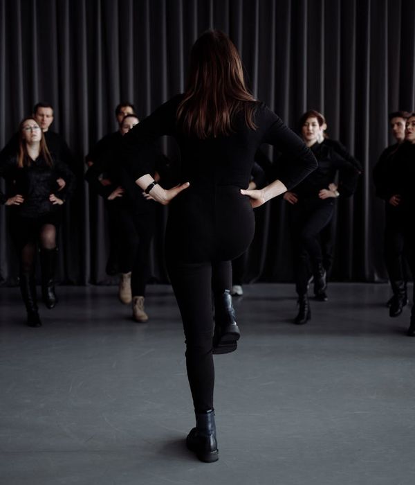 Person practicing gentle coordination movements in a dark room